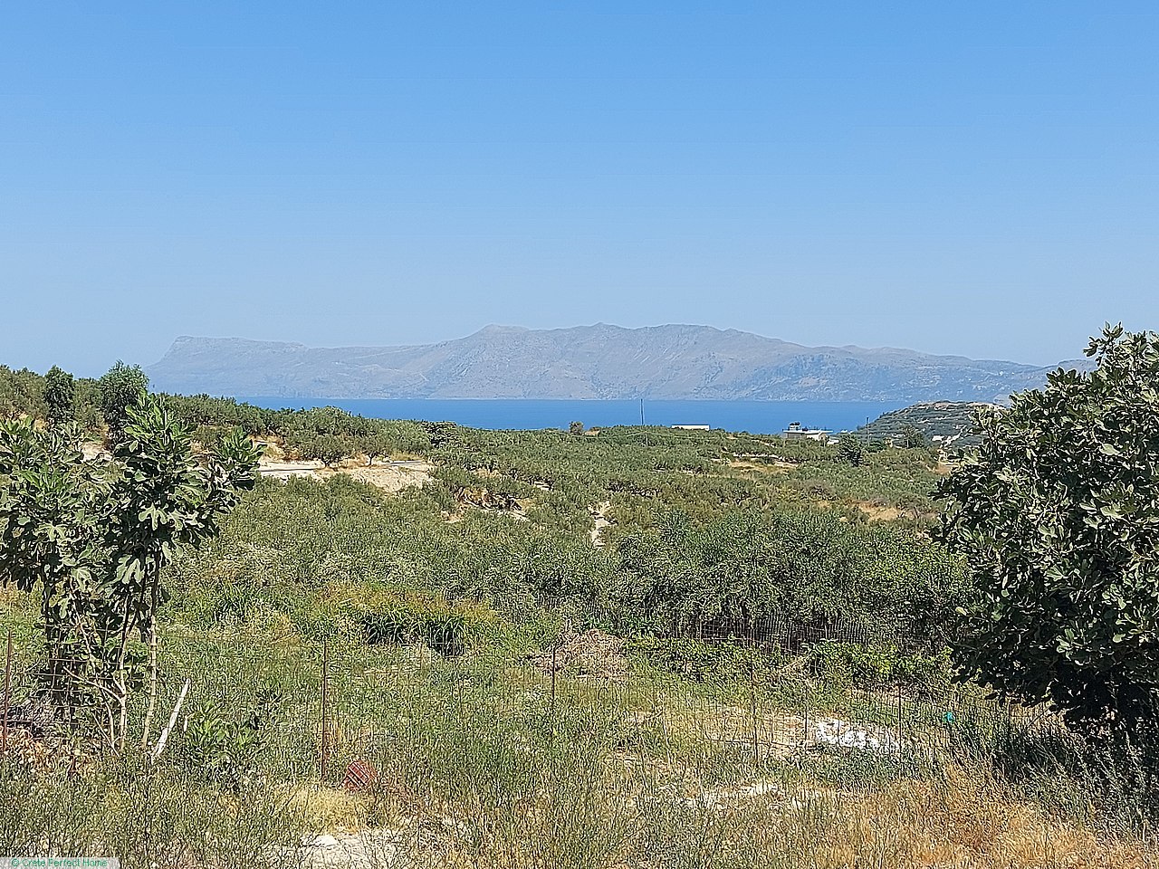 Large gently-terraced plot inside village, close to beaches, panoramic sea & rural views, large build allowance